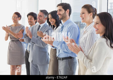 Applauding workers smiling and cheerful Stock Photo