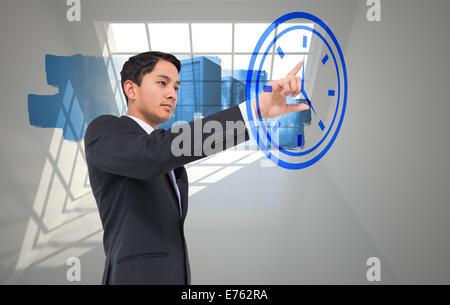 Composite image of serious asian businessman pointing Stock Photo