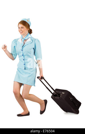 Pretty air hostess pulling suitcase Stock Photo
