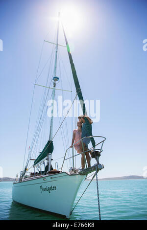 Couple standing on end of boat Stock Photo
