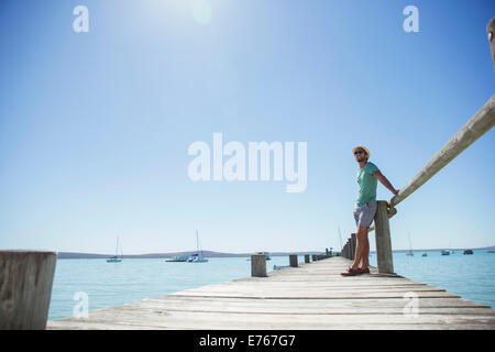 Man standing on wooden dock Stock Photo