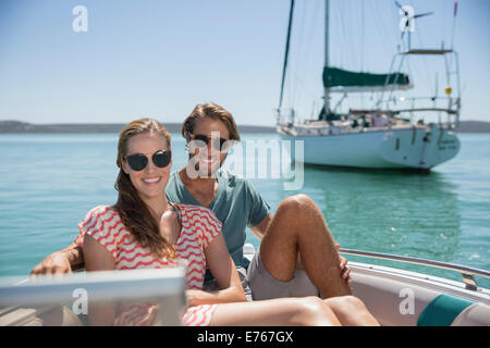 Couple sitting in boat on water Stock Photo