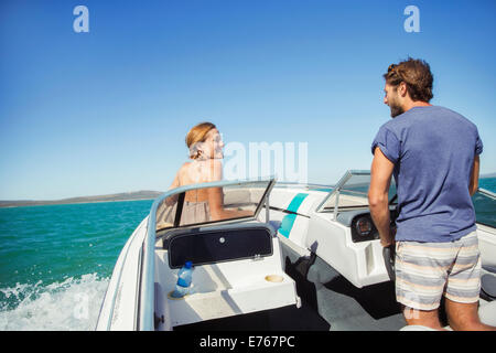 Man steering boat with girlfriend Stock Photo