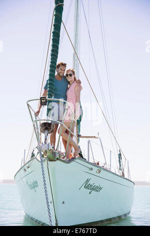 Couple standing on front of boat Stock Photo