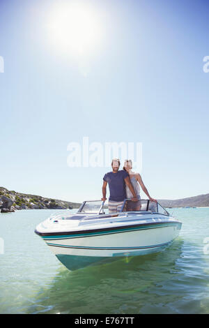 Couple standing in boat together Stock Photo