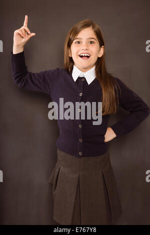 Cute pupil smiling at camera in library Stock Photo - Alamy