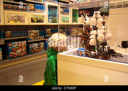 A boy looking at a display in the Lego Store on the shopping street Strøget in Copenhagen, Denmark A boy looking at a display in the Lego Store on the shopping street Strøget in Copenhagen, Denmark