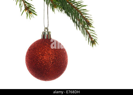 Red christmas bauble hanging from branch Stock Photo