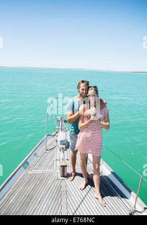 Couple standing on boat together Stock Photo