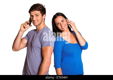 Young couple talking on their phones Stock Photo