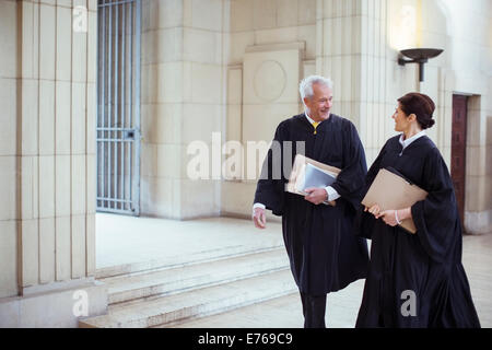 Judges walking through courthouse together Stock Photo