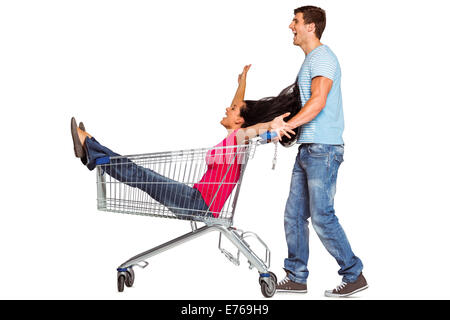 Young couple having fun with shopping cart Stock Photo