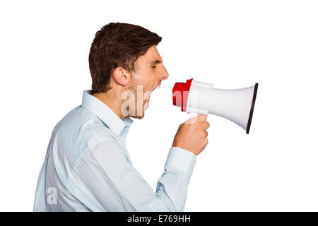 Young man shouting through megaphone Stock Photo
