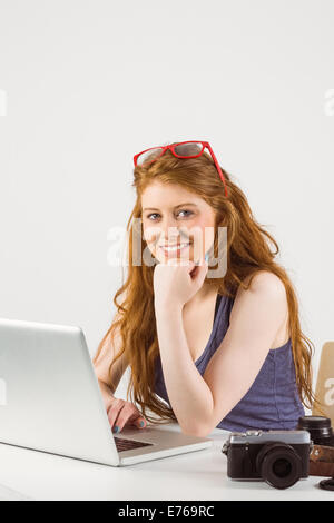 Pretty redhead working on laptop Stock Photo