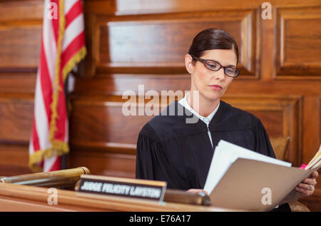 Judge looking through documents and judges bench Stock Photo