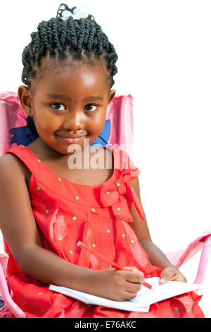 Close up portrait of cute little African girl with note book.Isolated on white background. Stock Photo