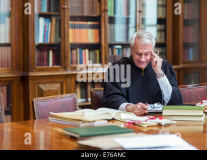 Judge reading documents in chambers Stock Photo