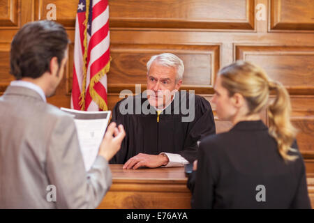 Lawyers pleading case to judge in court Stock Photo