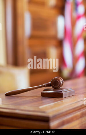 Gavel laying on judge’s bench in court Stock Photo