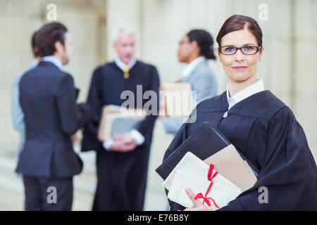 Judge holding legal documents in courthouse Stock Photo