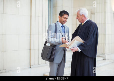 Judge and lawyer examining documents in courthouse Stock Photo