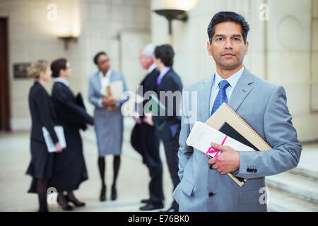 Lawyer holding legal documents in courthouse Stock Photo