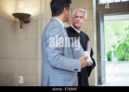 Judge and lawyer talking in courthouse Stock Photo