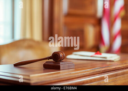 Gavel laying on judges bench in courtroom Stock Photo