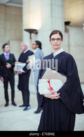 Judge holding legal documents in courthouse Stock Photo