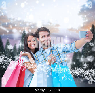Composite image of happy couple taking a selfie Stock Photo