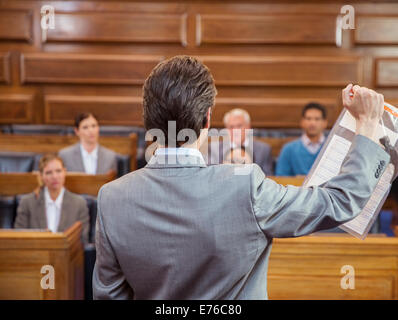 Lawyer showing documents to jury in court Stock Photo