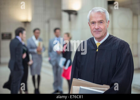 Judge holding legal documents in courthouse Stock Photo