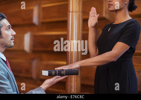 Bailiff giving oath to witness Stock Photo