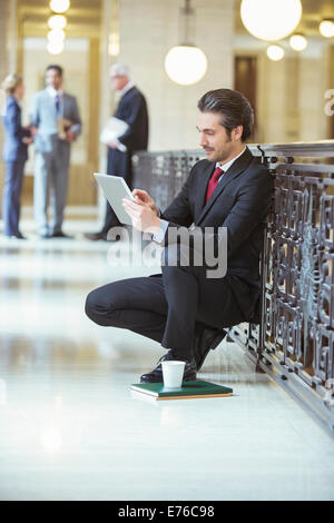 Lawyer doing work on digital tablet in courthouse Stock Photo