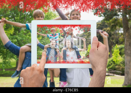 Composite image of hands holding tablet pc Stock Photo