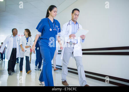 Doctor and nurse reading medical chart in hospital Stock Photo