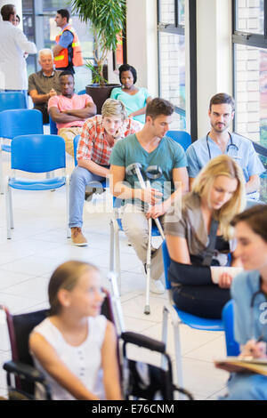 Patients in hospital waiting room Stock Photo