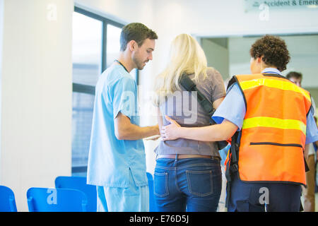 Paramedic and nurse helping patient in hospital Stock Photo
