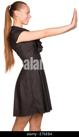 Isolated young casual woman push imaginary wall Stock Photo