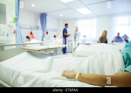 Patient laying in hospital bed Stock Photo