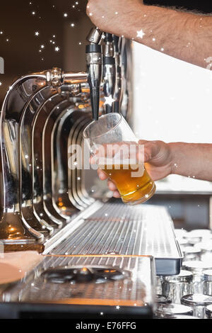 Composite image of bartender pulling a pint of beer Stock Photo