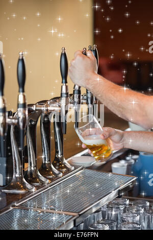 Composite image of barman pulling a pint of beer Stock Photo