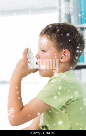 Composite image of boy using asthma inhaler in hospital Stock Photo