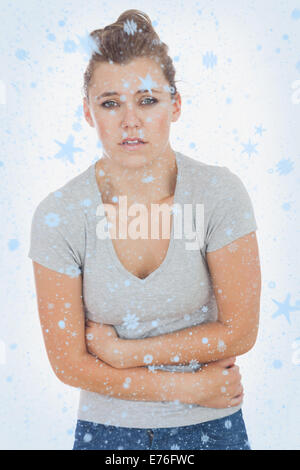 Composite image of young woman suffering from stomach ache Stock Photo