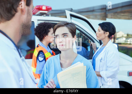 Doctor and nurse talking outside hospital Stock Photo