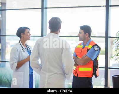 Doctors and paramedic talking in hospital Stock Photo