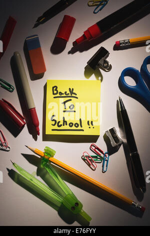 Students table with school supplies Stock Photo