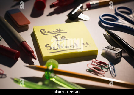 Students table with school supplies Stock Photo