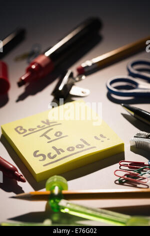 Students table with school supplies Stock Photo