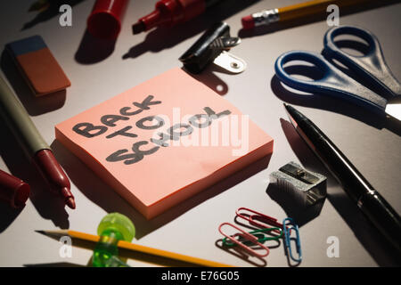 Students table with school supplies Stock Photo